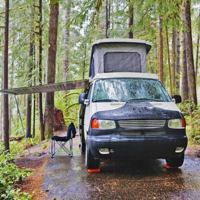 road trip camper parked in forest