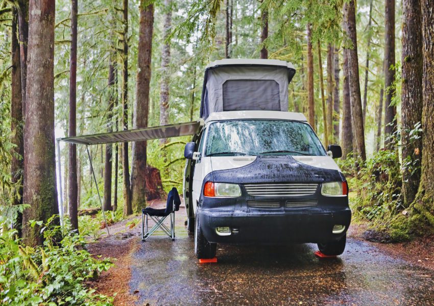road trip camper parked in forest